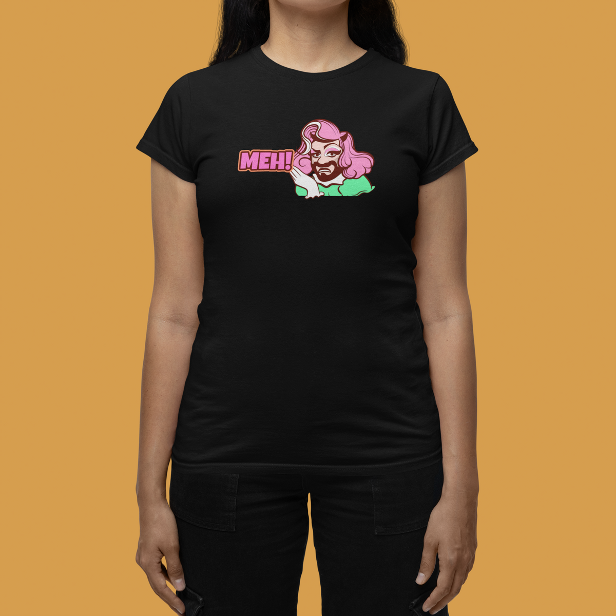 'MEH!' funny pink haired character women's tee in black, woman wearing it orange background, funny gift