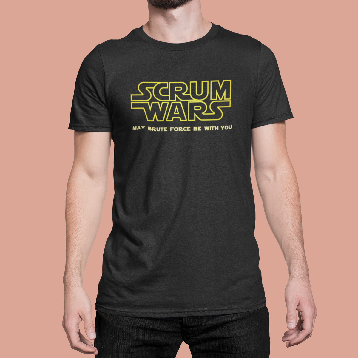 "Scrum Wars" t-shirt in black, man modeling it on a peach background, funny gift for scrum masters