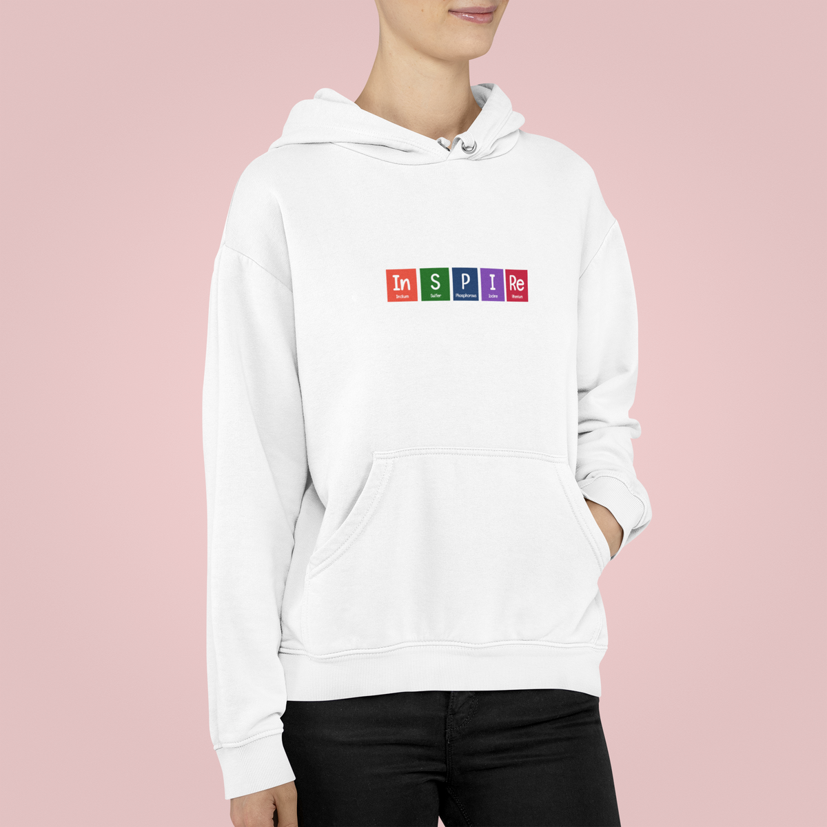 'InSPIRe' periodic table hoodie in white, woman wearing it, pink backdrop, funny science hoodie