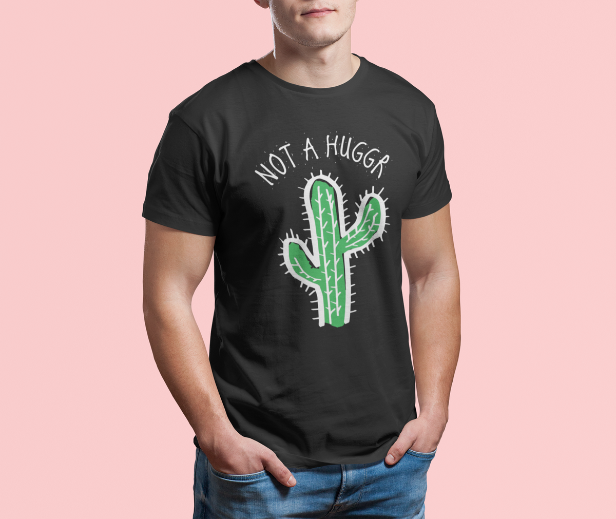 Not a Hugger cactus tee in black, man wearing it against a pink background, funny sarcastic gift shirt