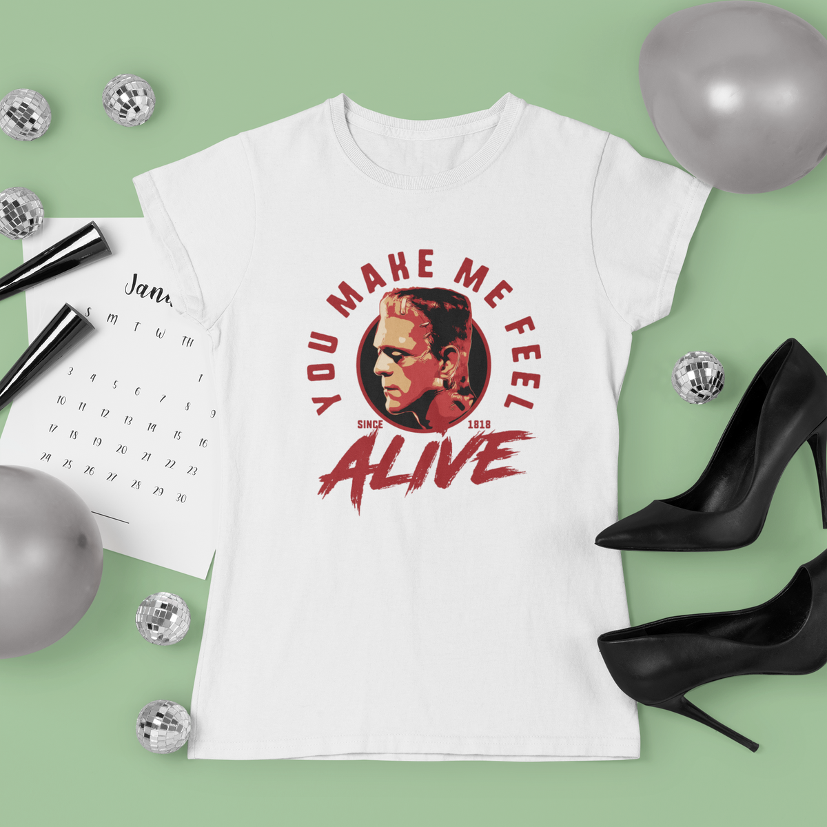 "You Make Me Feel Alive" portrait graphic t-shirt in white, flat lay with party decor, cool gift for movie fans