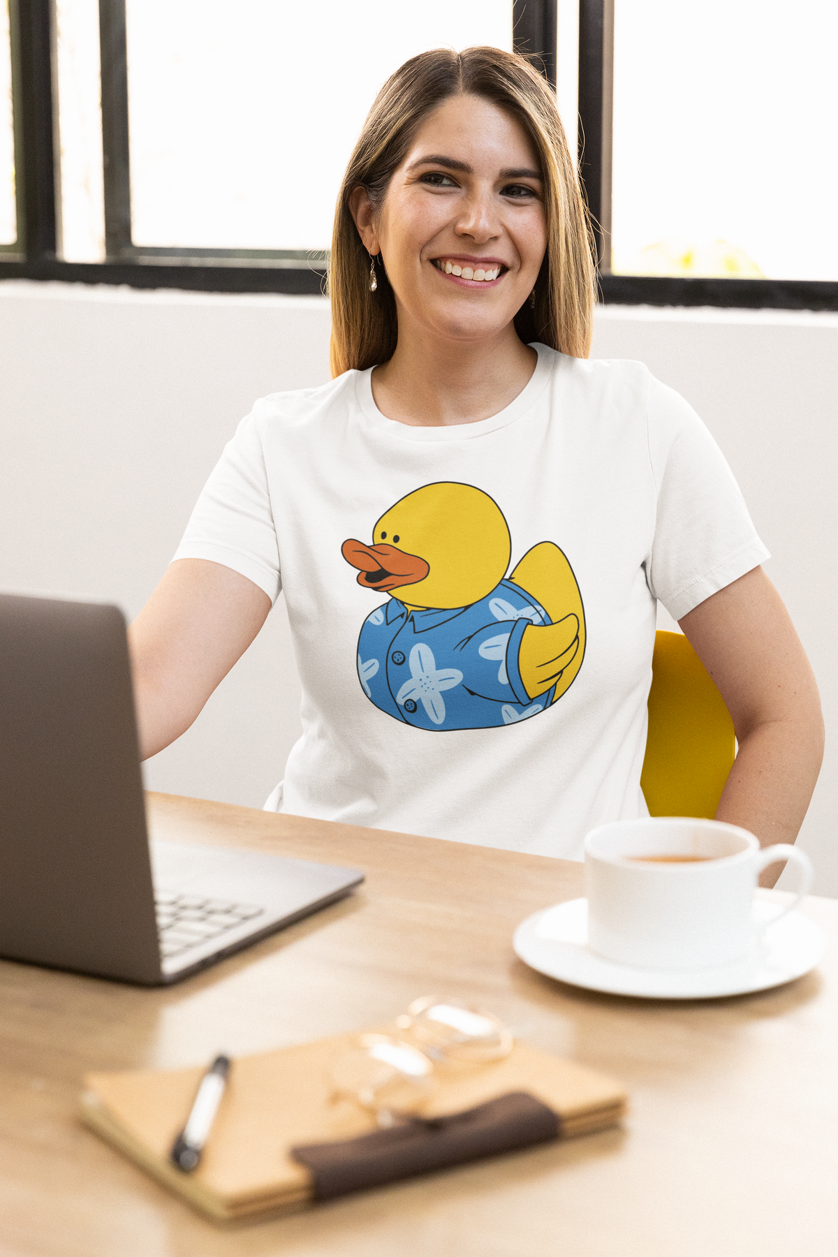 Hawaii duck t-shirt in white, woman model wearing it at a desk with a laptop, funny beach vacation gift
