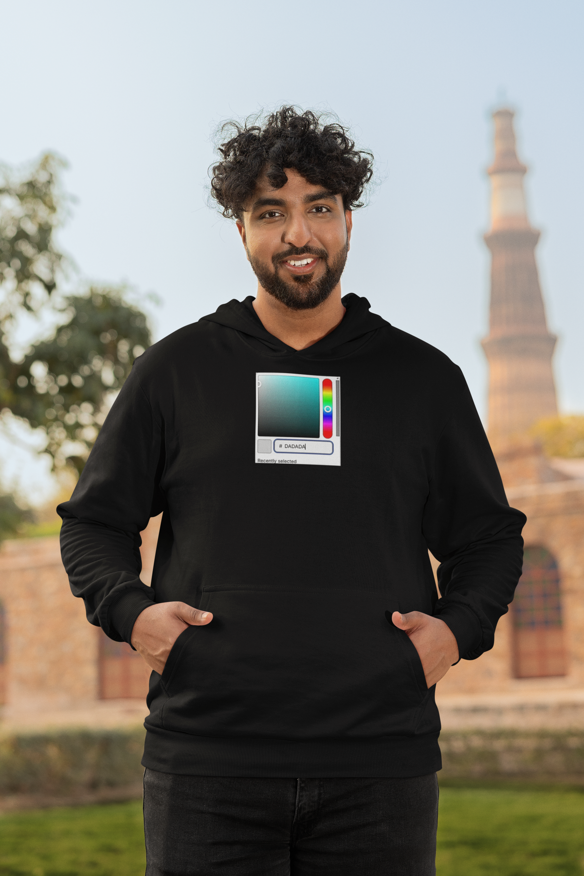 'DADA Paint Hoodie' in black, man by a historic building, Hoodie mockup, Geekpsters