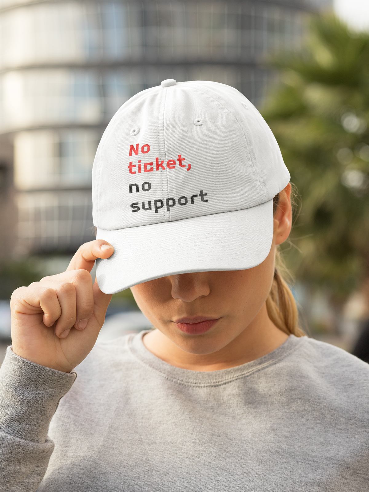 'No Ticket No Support' dad hat in white, woman wearing it outdoors, funny sysadmin gift