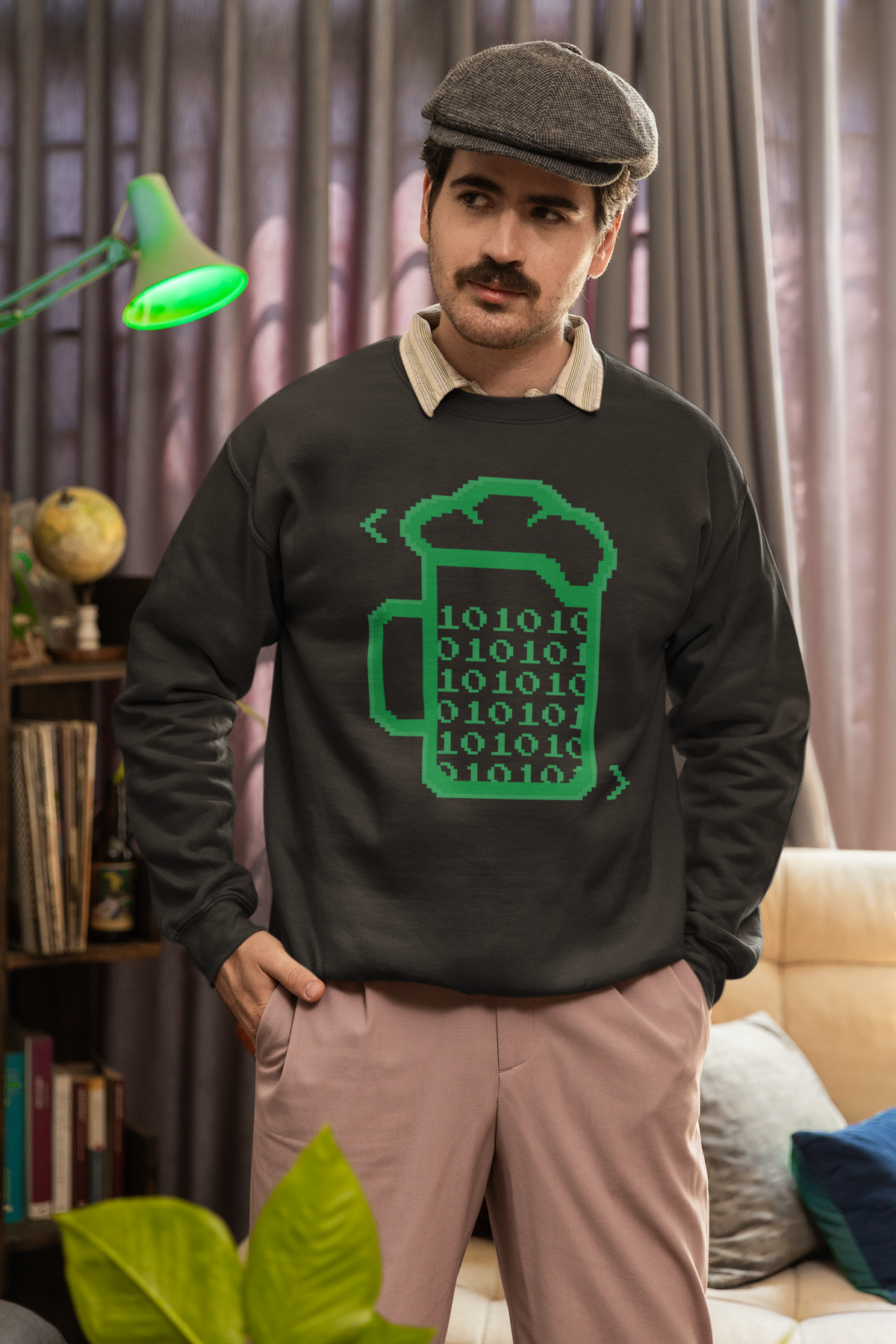 Beer Code binary mug sweatshirt in dark grey, man in a flat cap wearing it indoors, geek gift for him