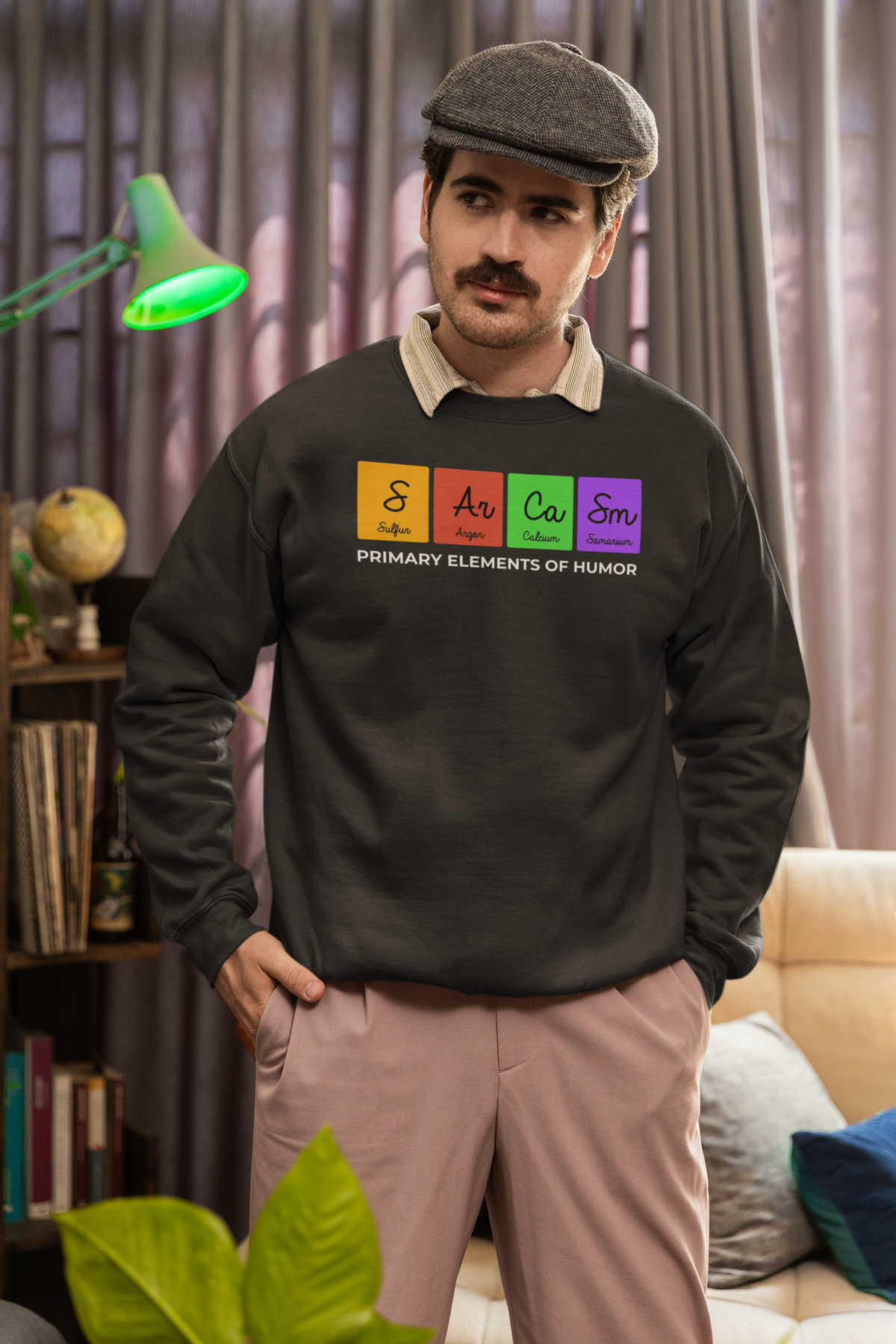 'Sarcasm, Primary Elements of Humor' periodic table sweatshirt in charcoal, man wearing it at home, funny gift