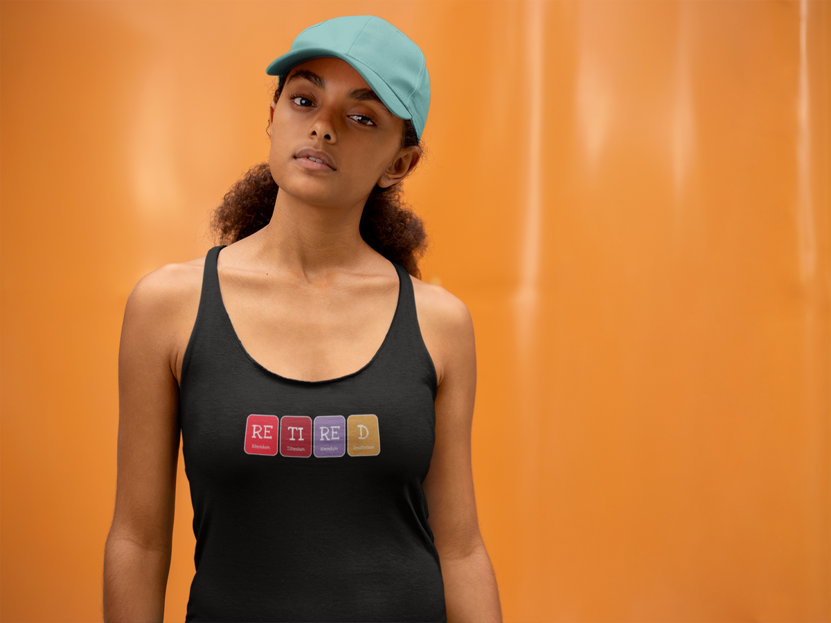 'Retired Periodic Table Women's Tank' in black, woman by an orange wall, Tank Top mockup, Geekpsters