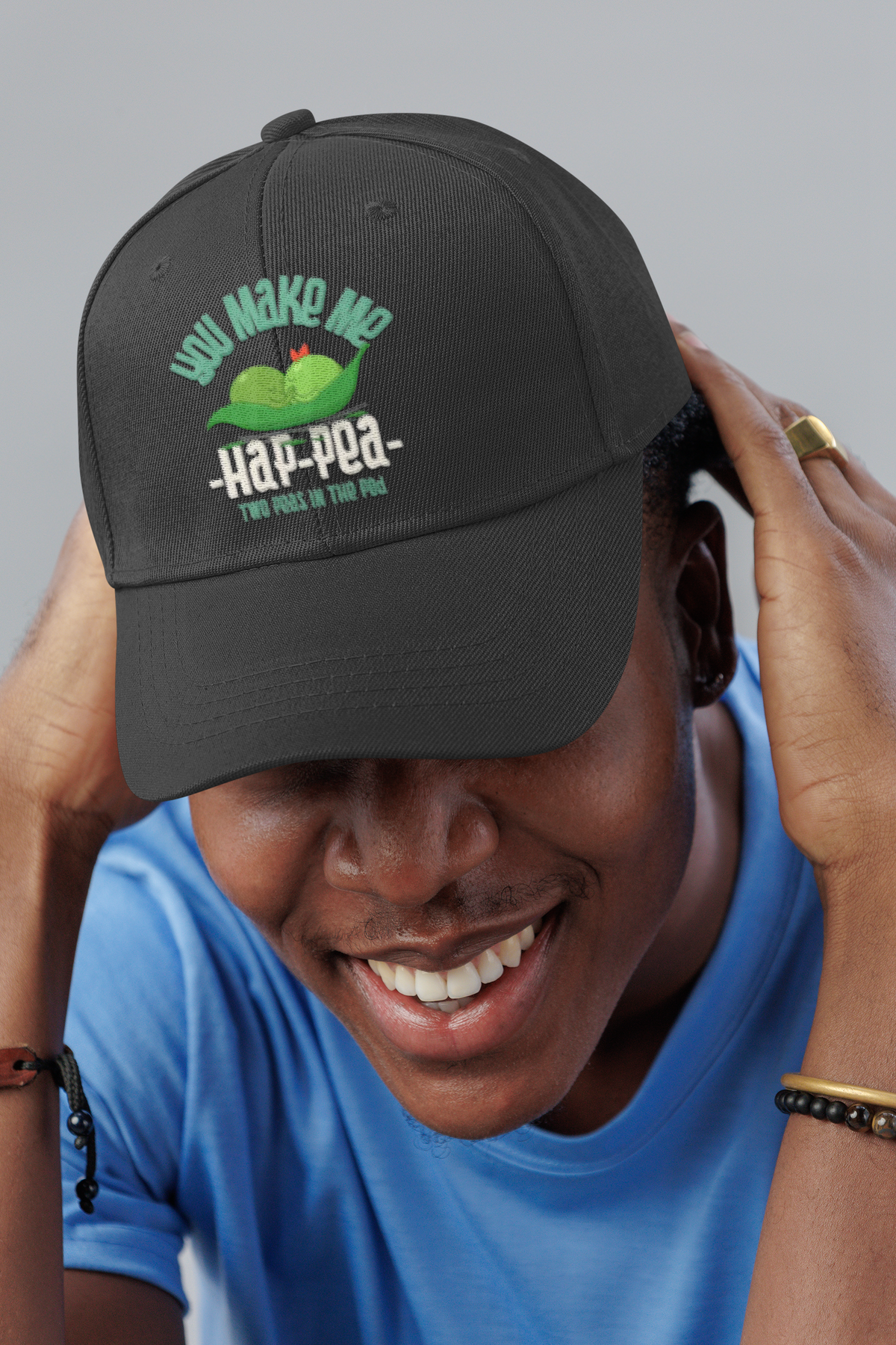 You Make Me Ha Pee embroidered dad hat worn by a smiling man in a studio, lifestyle mockup, Geekpsters