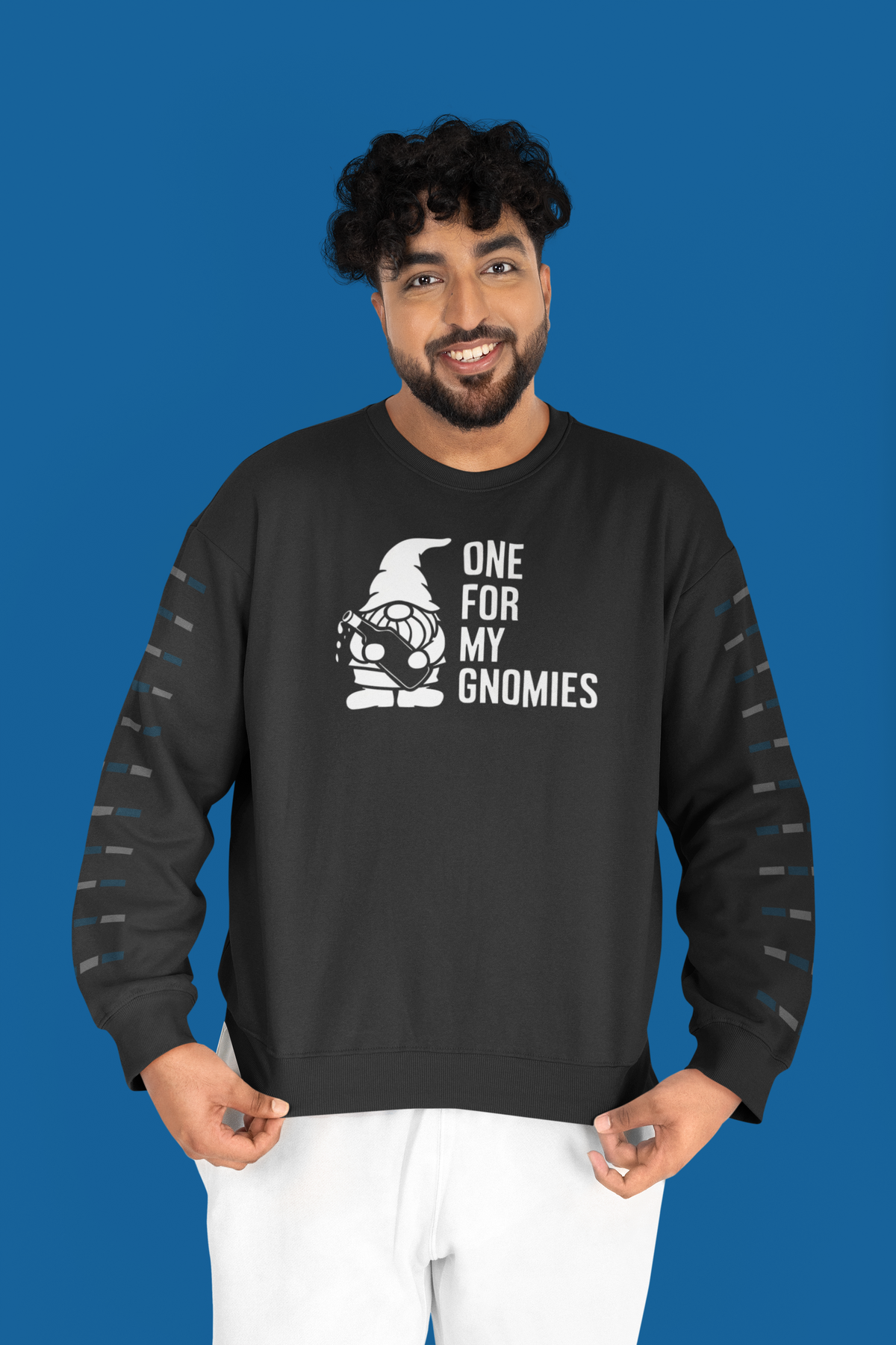 One For My Gnomies sweatshirt in black, man wearing it against a blue backdrop, funny gnome pun gift