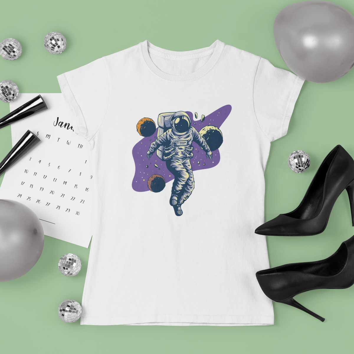 'Spacing Out' astronaut t-shirt in white, lifestyle flat lay with heels and planner, funny space gift for her