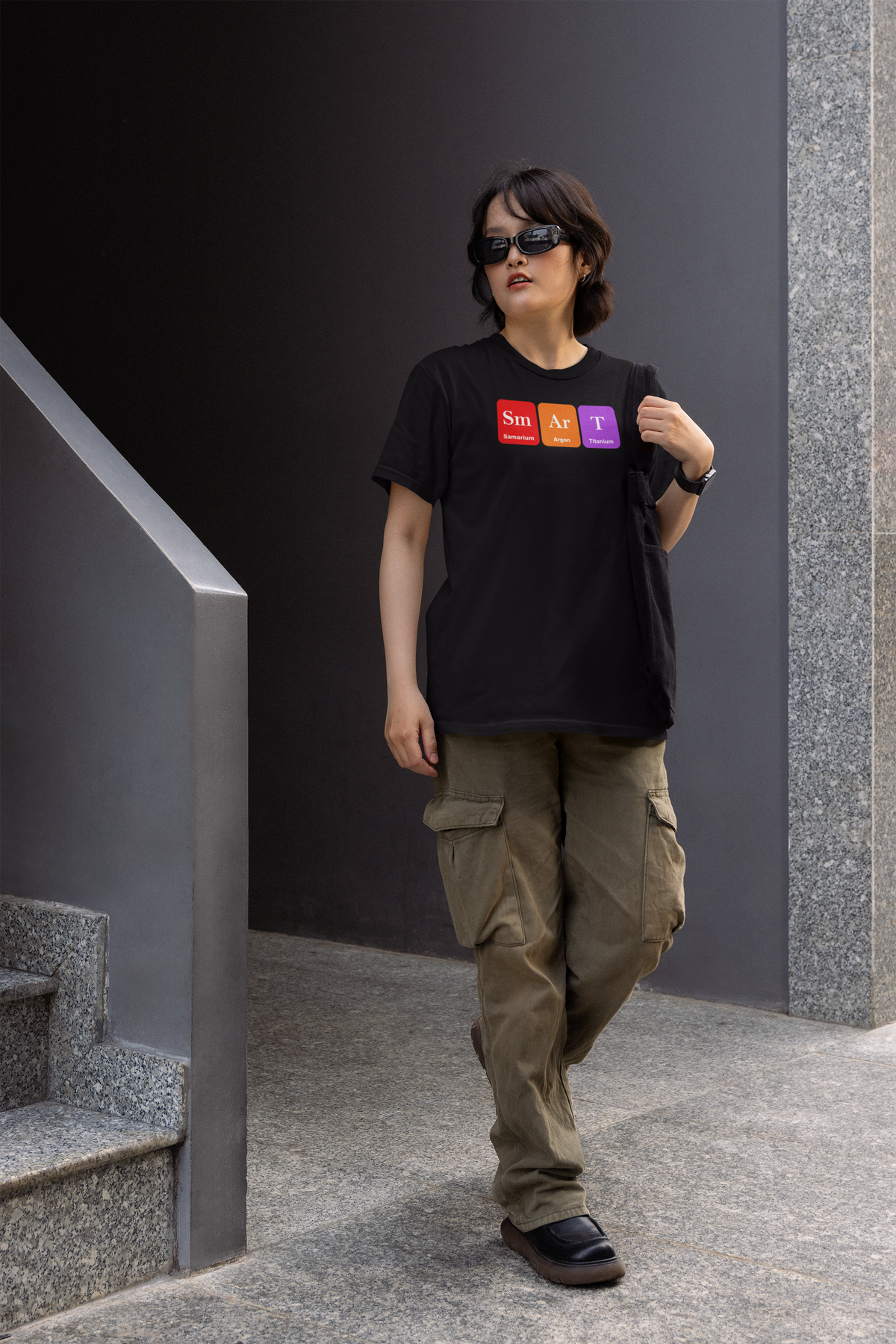 'Smart' periodic table women's t-shirt in black, woman wearing it on stairs outdoors, funny chemistry gift