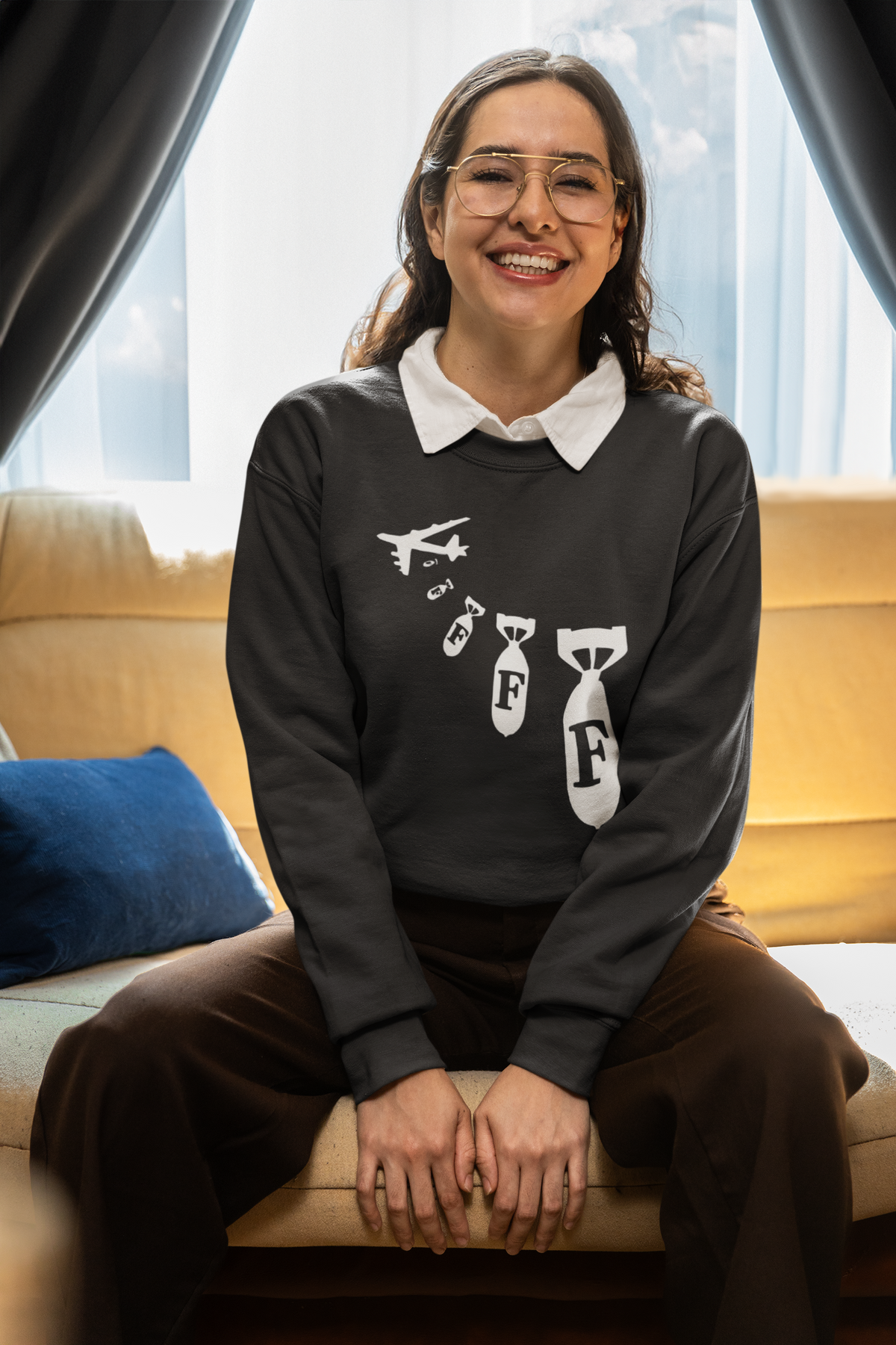 "F Bomb" sweatshirt in black, woman sitting indoors wearing glasses, funny sarcastic gift sweatshirt
