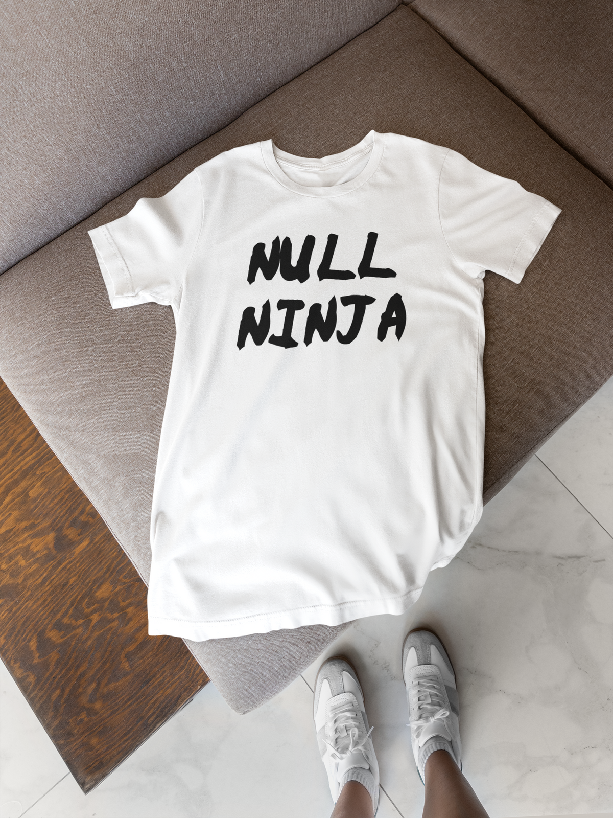'Null Ninja' t-shirt in white, flat lay on a wood floor, funny gift for programmers