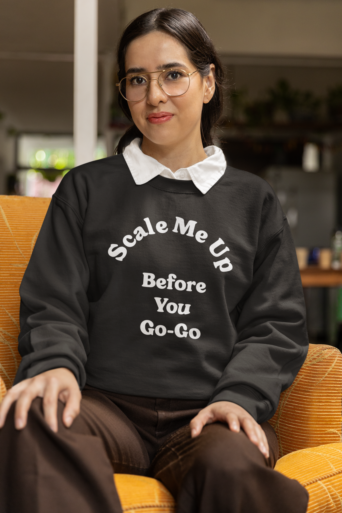 'Scale Me Up Before You Go-Go' sweatshirt in charcoal, woman sitting on a couch, funny sysadmin sweatshirt gift