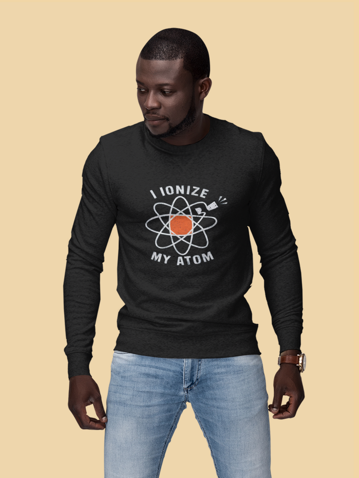 'I Ionize My Atom' sweatshirt in black, man wearing it on tan background, funny science teacher gift