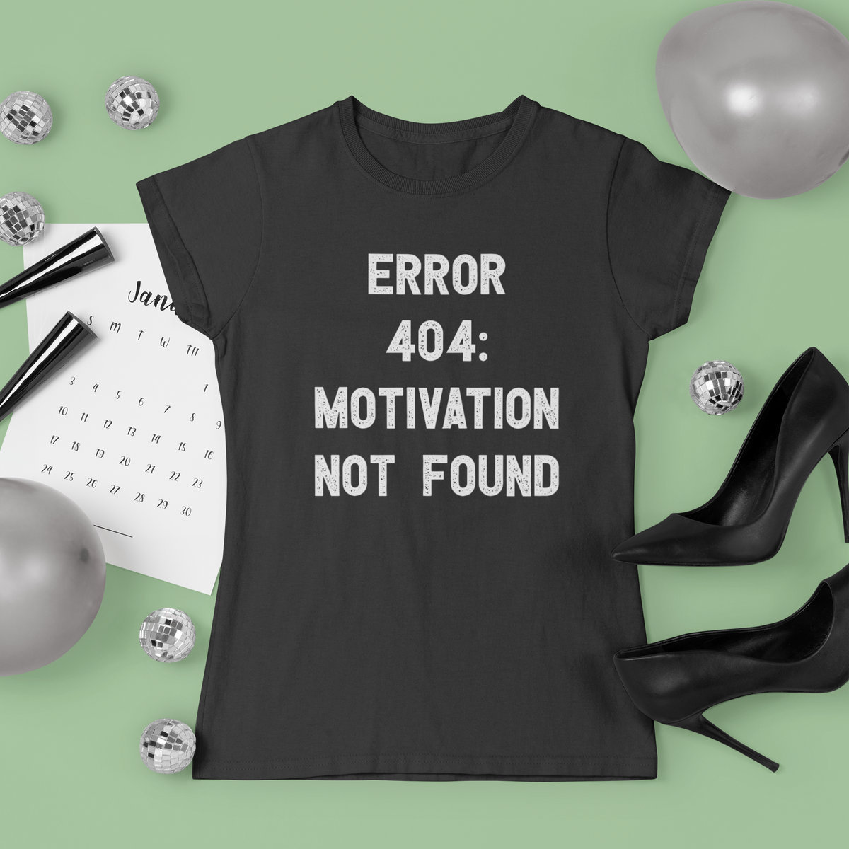 'Error 404 Motivation Not Found' t-shirt in black, flat lay with heels styling, funny programmer tee gift