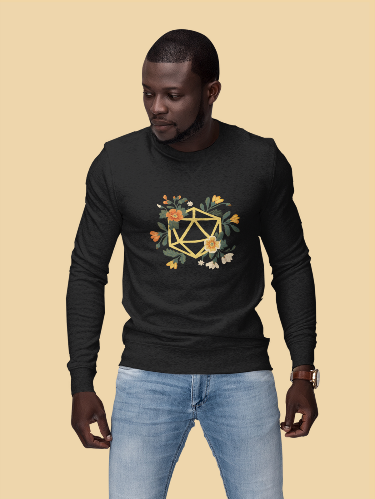 Flower Polyhedron Sweatshirt in black, man wearing it against mustard backdrop, floral d20 gift for gamers