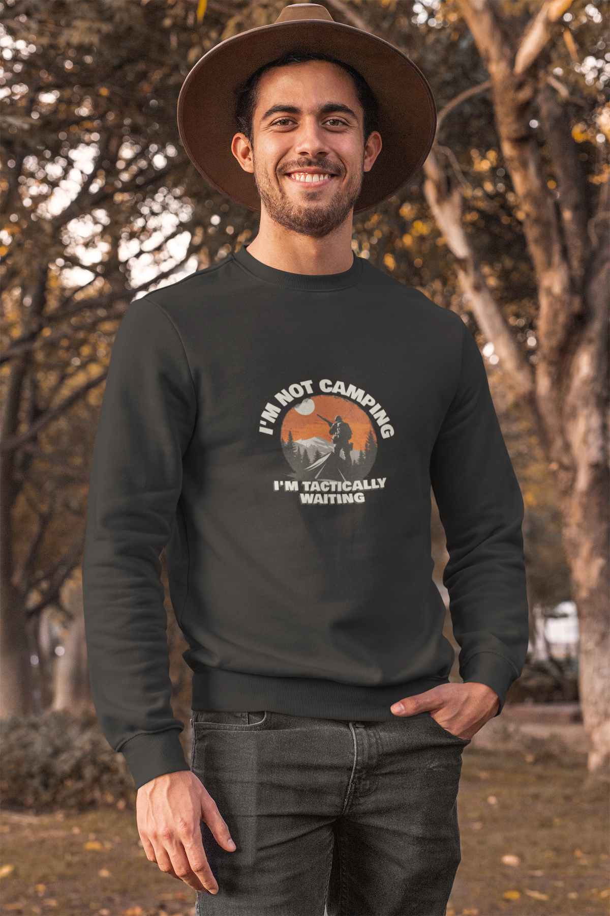 'I'm Not Camping' hiker graphic sweatshirt in black, man wearing it outdoors with a hat, camping gift