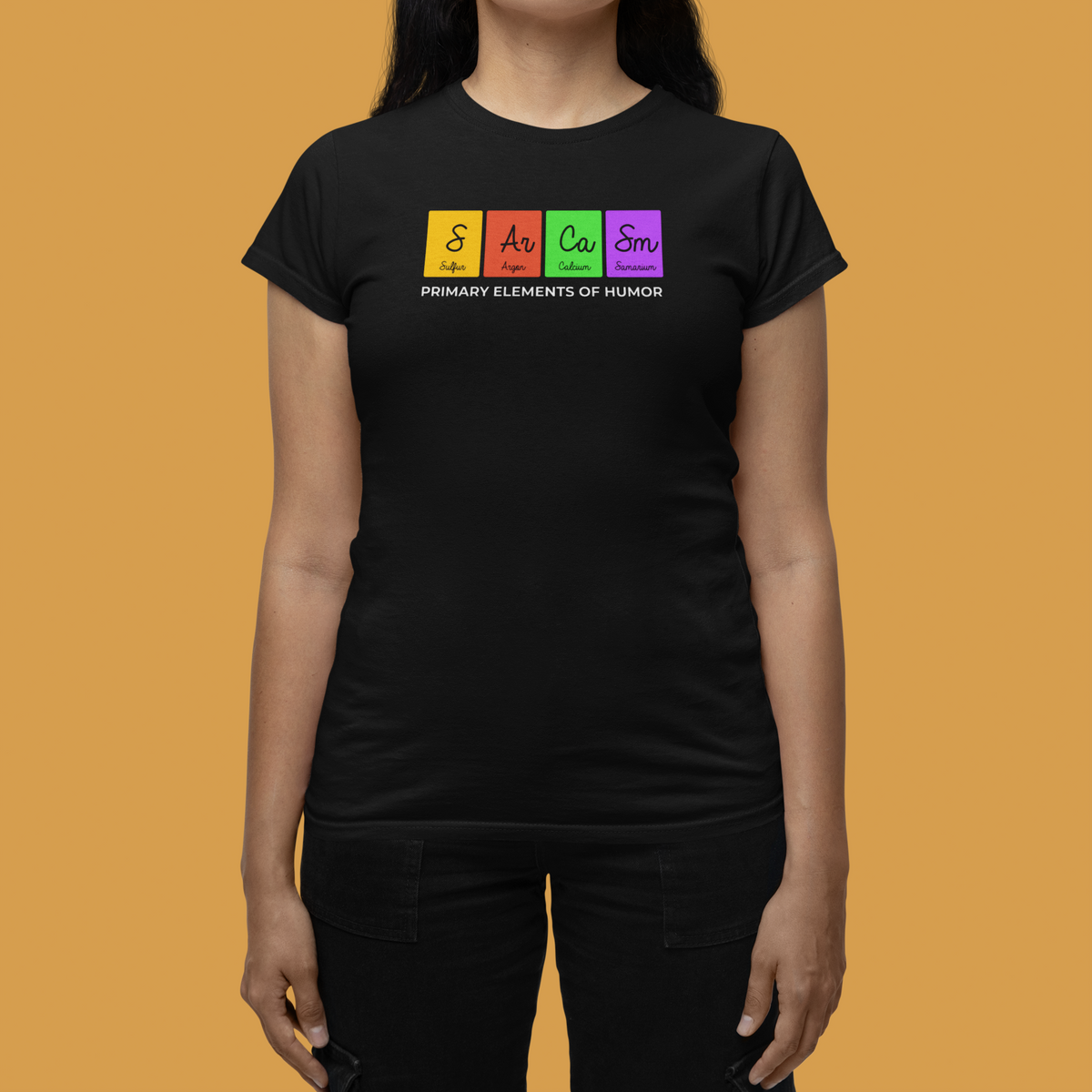 'Sarcasm, Primary Elements of Humor' periodic table women's tee in black, flat lay on torso, funny science gift