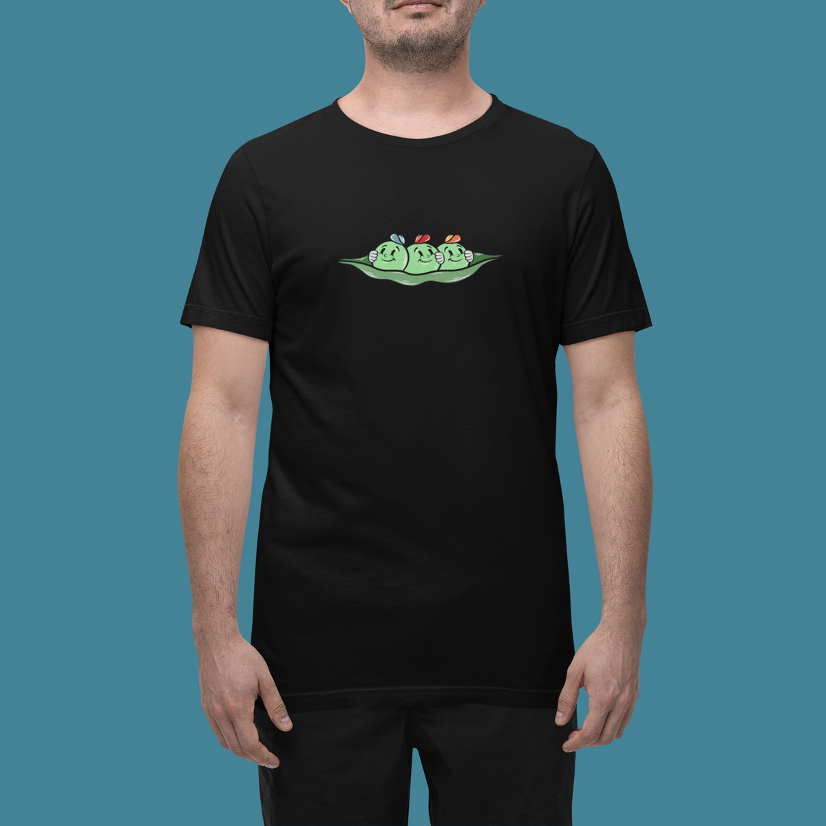 'Peas Cartoon' t-shirt in black, man wearing it in a studio, T-Shirt mockup, Geekpsters