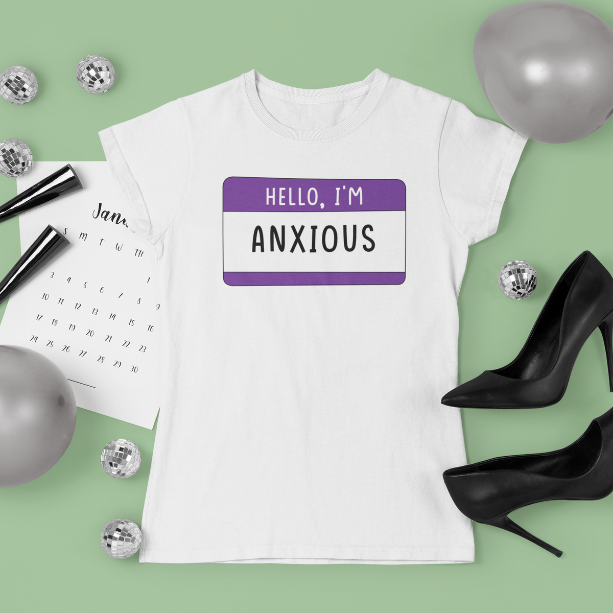 Hello I'm Anxious T-shirt in white, flat lay styled with dice and heels, funny anxiety gift tee