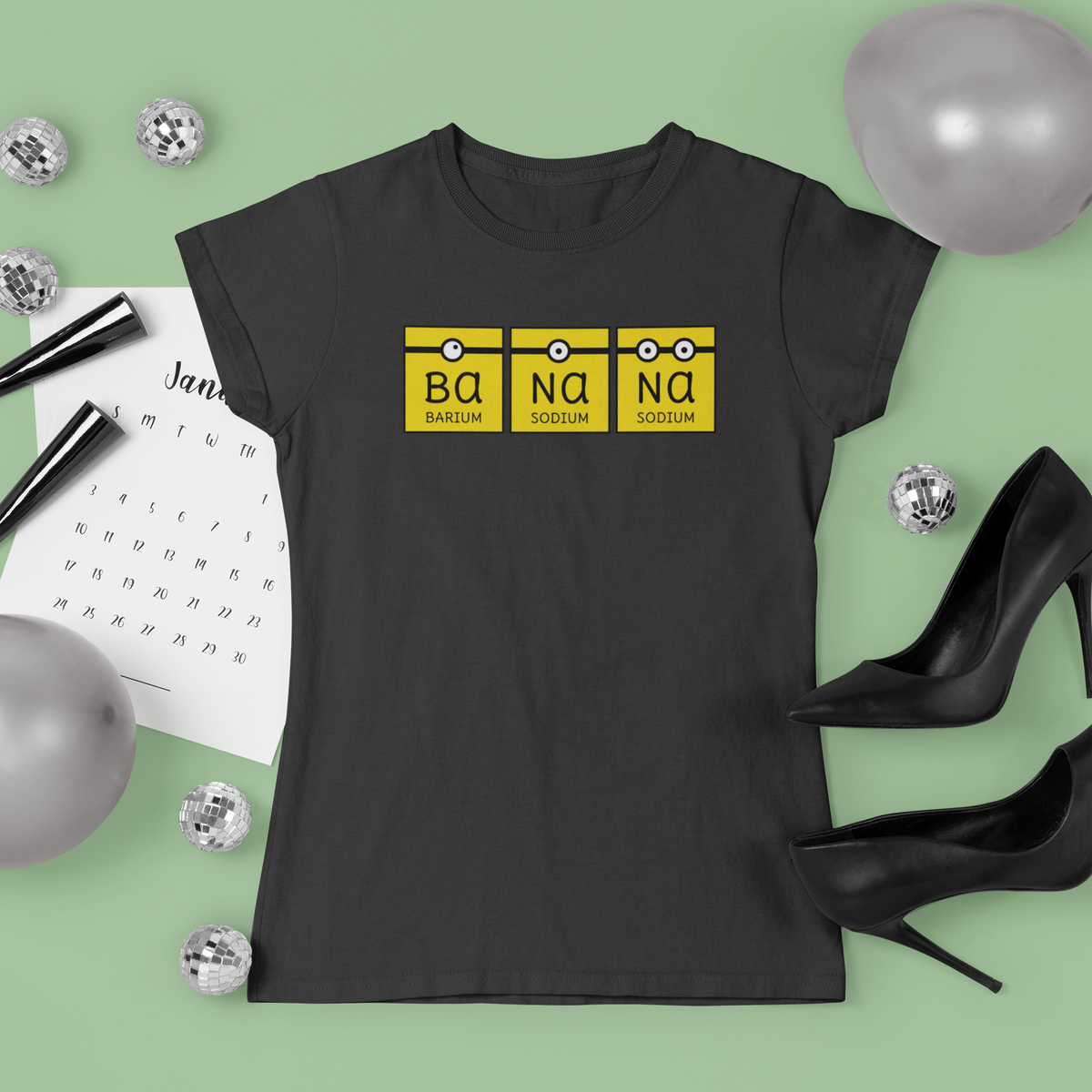 'Banana' periodic table T-shirt in black, flat lay with festive props, funny chemistry gift shirt