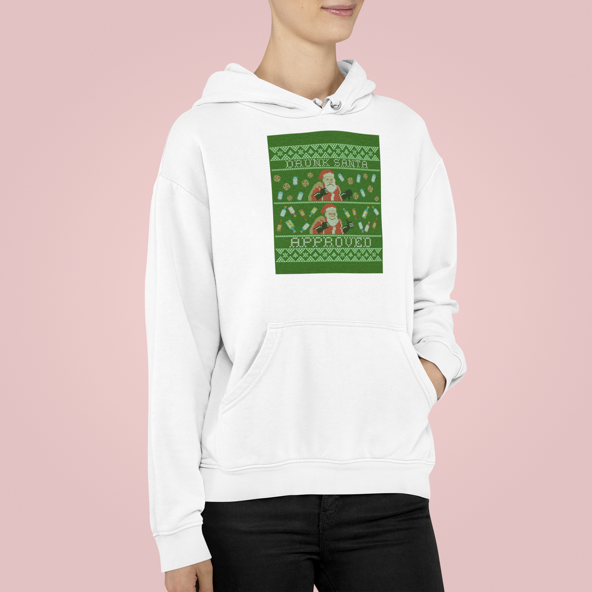 'Drunk Santa Approved' Santa graphic hoodie in white, woman wearing it on pink backdrop, funny Christmas gift
