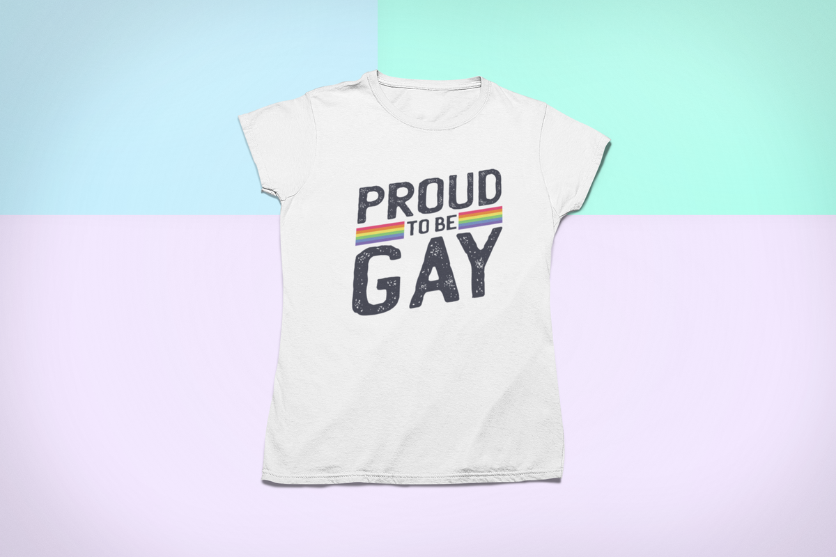 'Proud to Be Gay' T-shirt in white, flat lay on a pastel backdrop, funny gay pride gift shirt