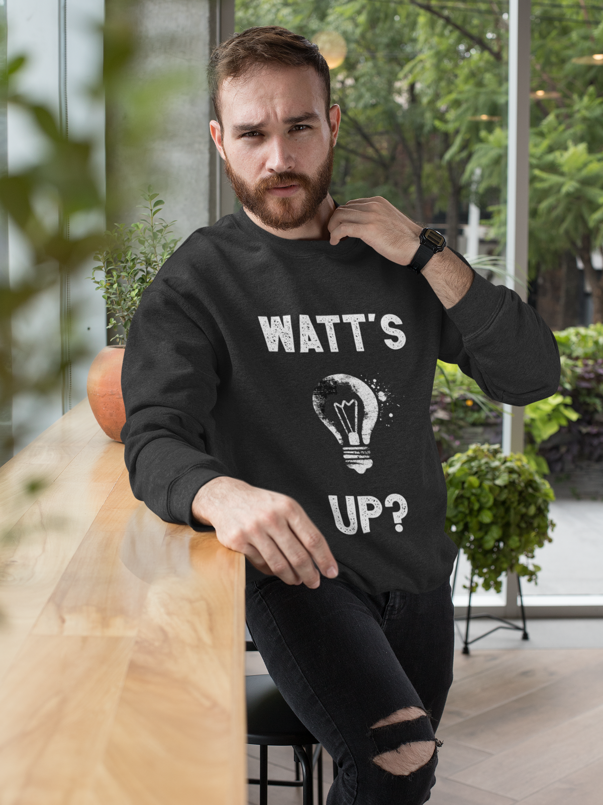 'Watt's Up?' sweatshirt in black, bearded man indoors, funny electrician pun sweatshirt gift