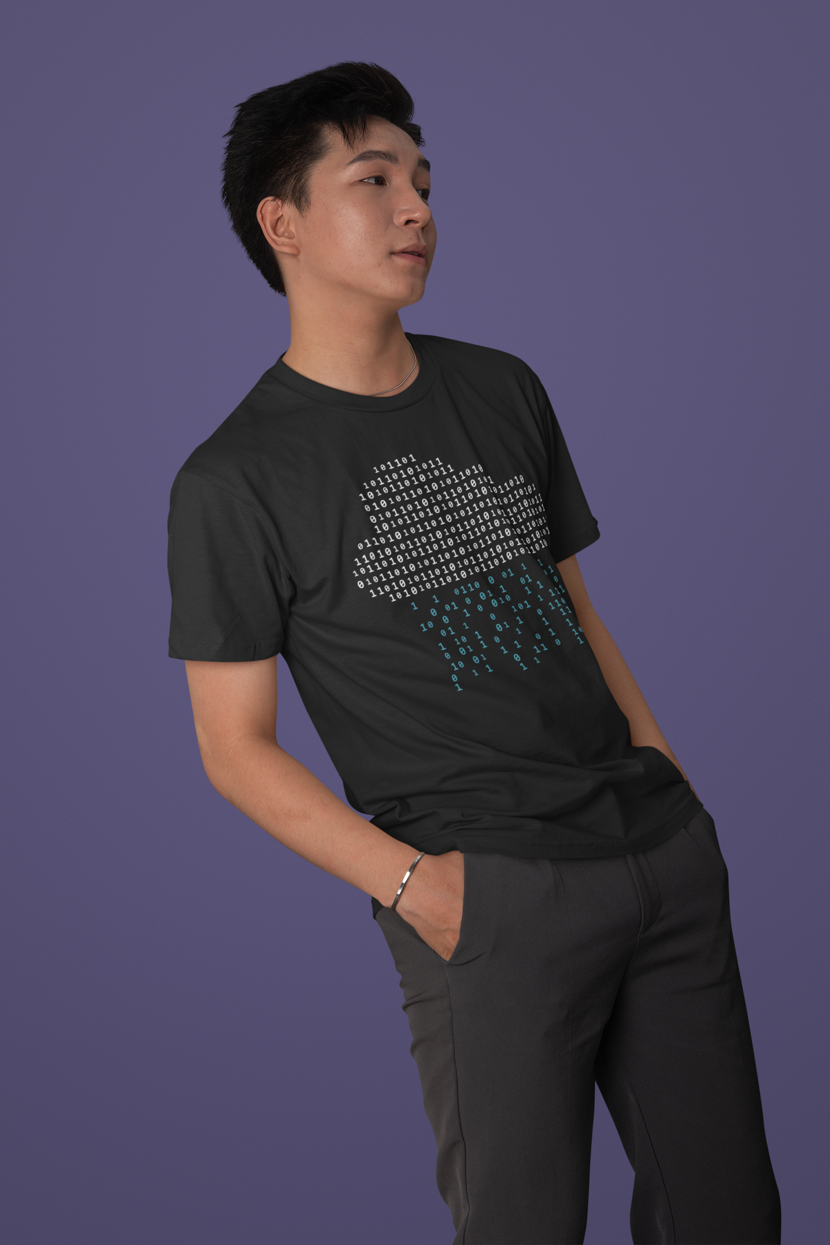 'It's Raining Code' cloud binary t-shirt in black, man model wearing it against a purple background, developer gift