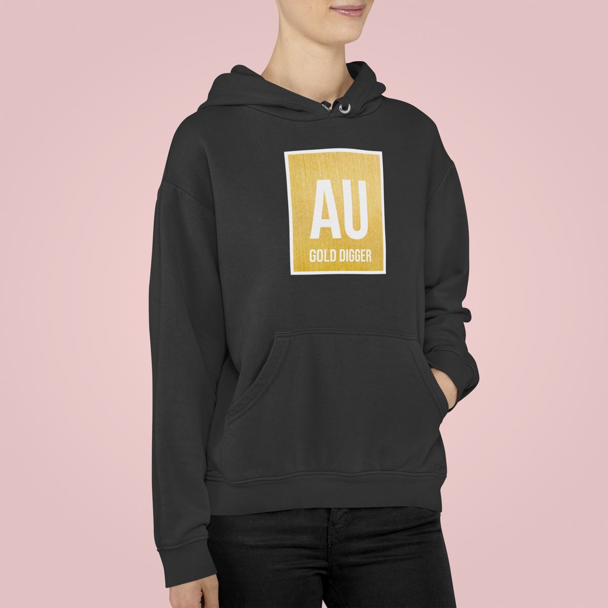 'AU Gold Digger' hoodie in black, woman wearing it against pink backdrop, funny chemistry pun gift