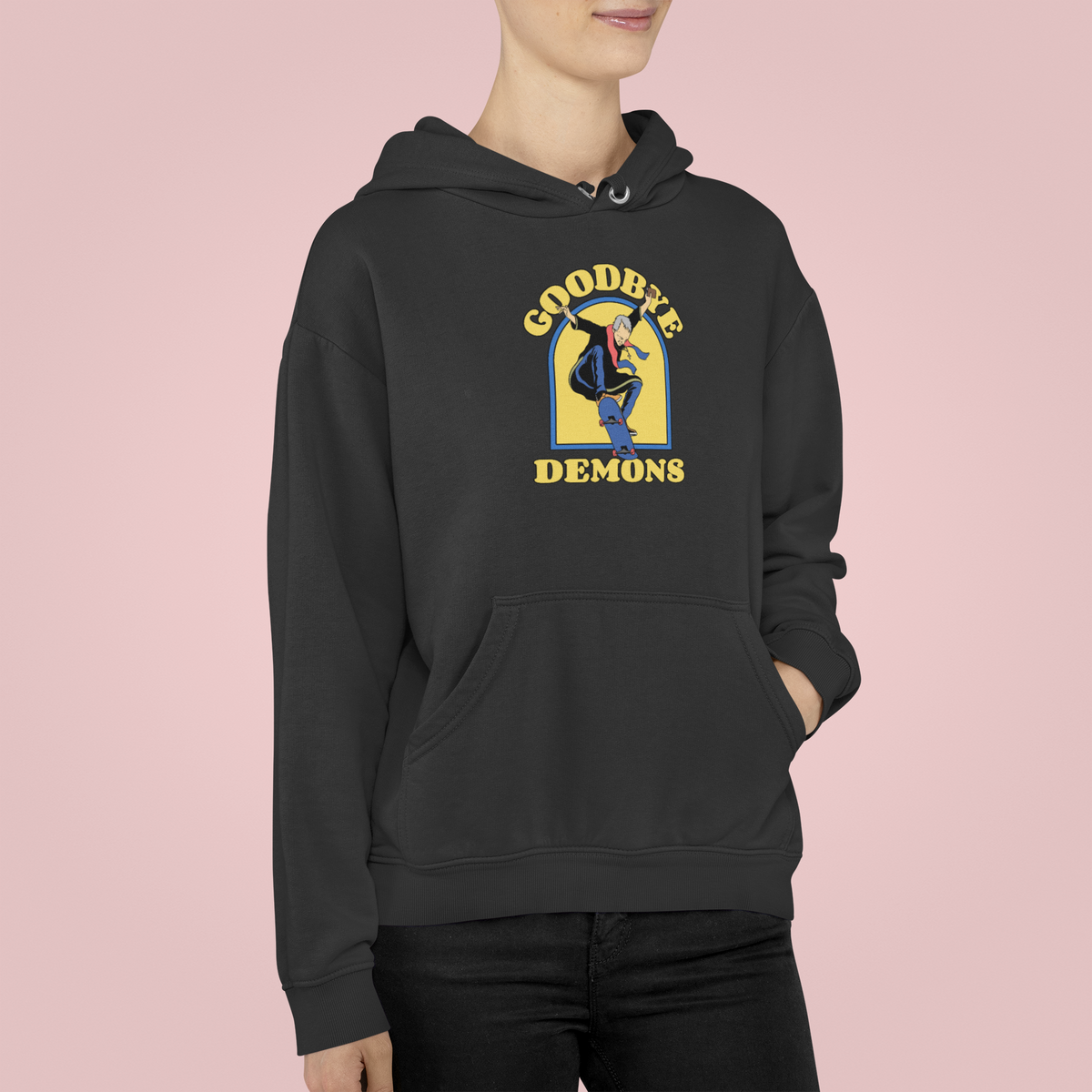 'Goodbye Demons' funny exorcist skater hoodie in black, woman wearing it, pink background, funny gift