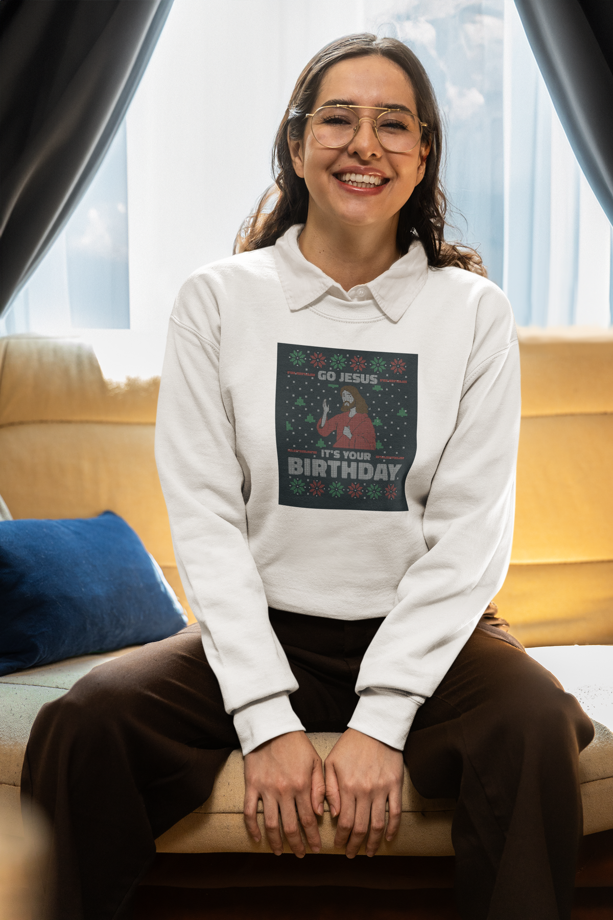 'Go Jesus It's Your Birthday Ugly Sweater Sweatshirt' in white, smiling woman indoors, Sweatshirt mockup, Geekpsters