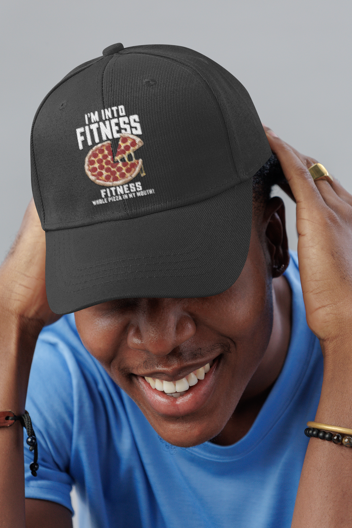 I'm Into Fitness pizza pun embroidered dad hat worn by a smiling man in a studio, lifestyle mockup, Geekpsters