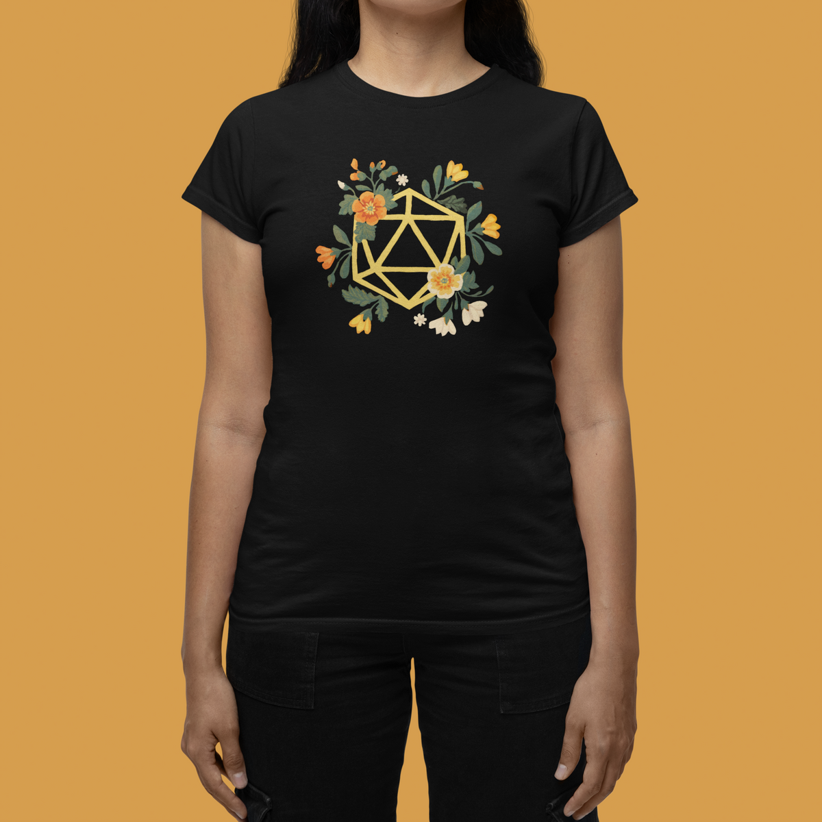Flower Polyhedron Women's Tee in black, woman wearing it against mustard backdrop, floral dnd inspired tee