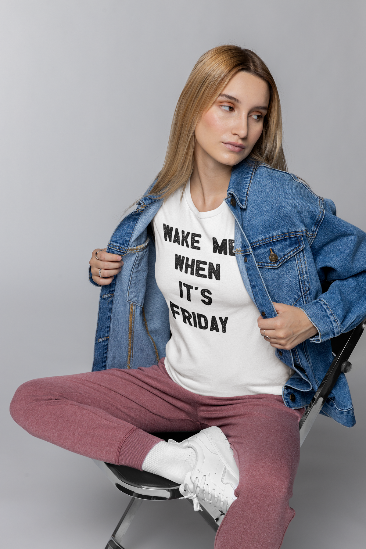 "Wake Me When It's Friday" t-shirt in white, woman wearing it with denim jacket, funny weekend gift for her