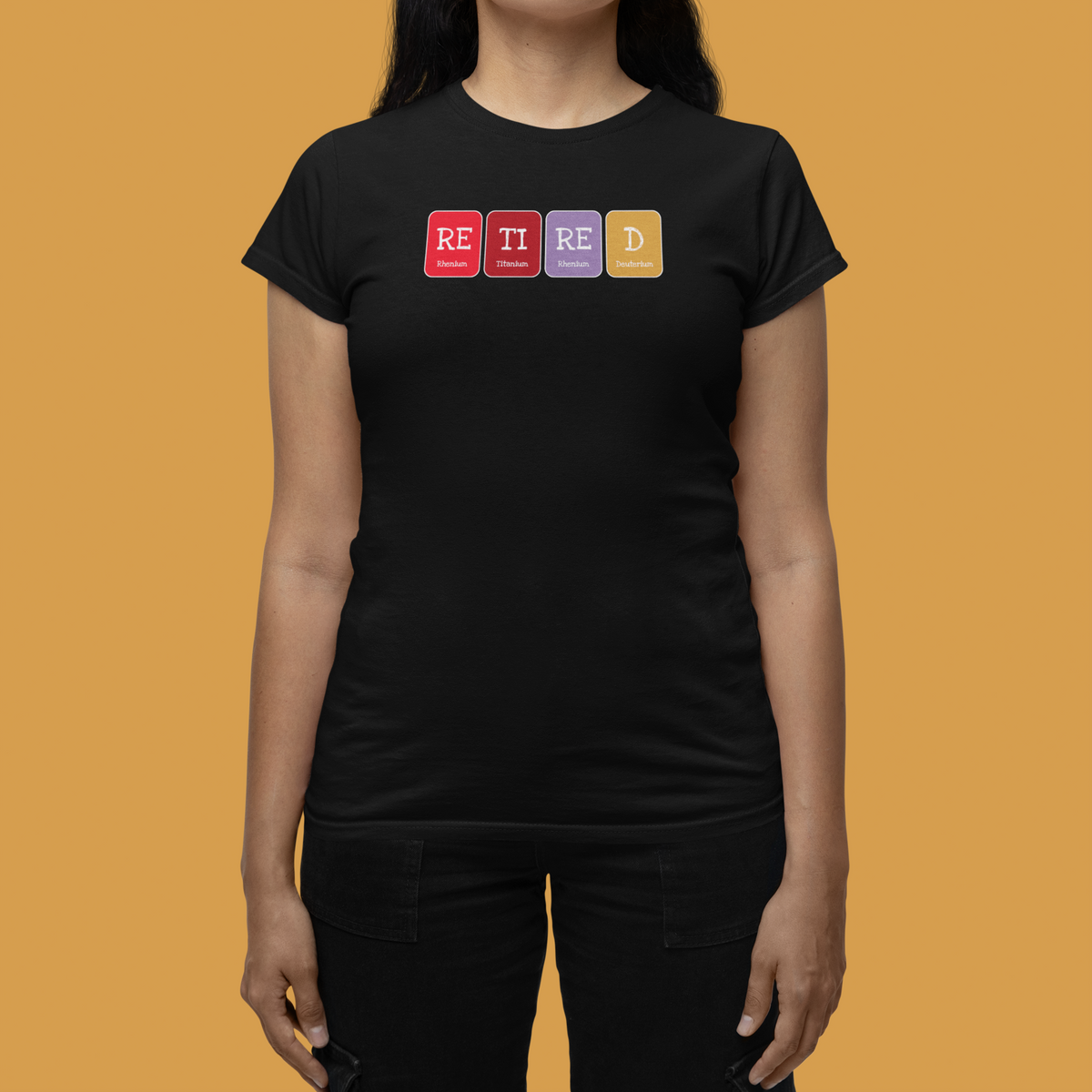 'Retired' periodic table women's tee in black, woman walking outdoors, casual streetwear photo