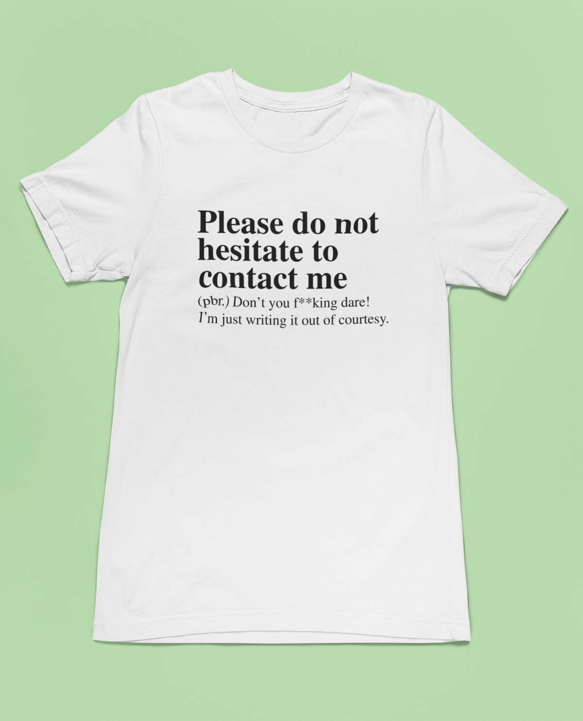 'Please Do Not Hesitate to Contact Me' T-shirt in white, flat lay on pale green background, gift tee
