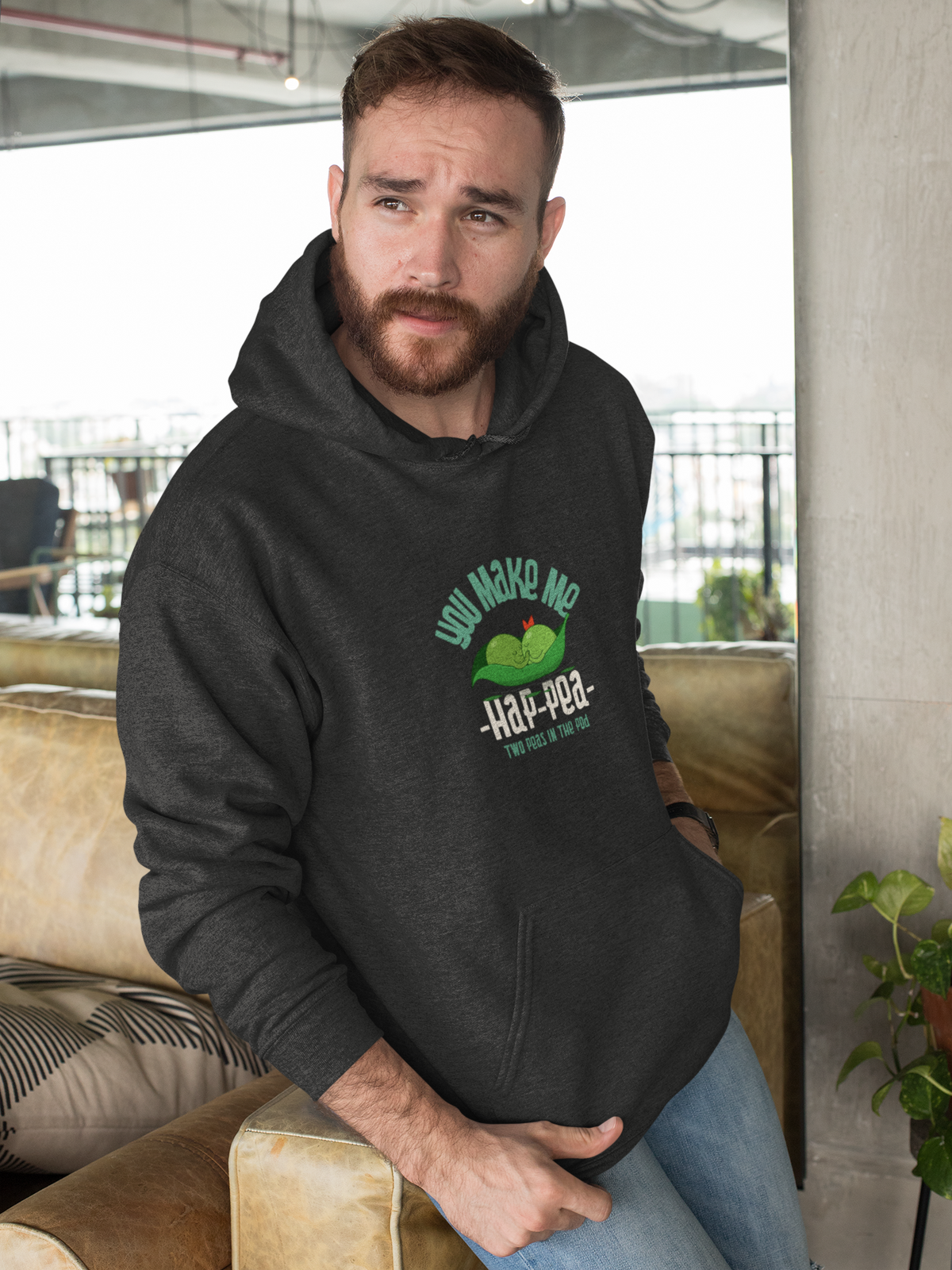 'You Make Me Ha-Pea' pea pun hoodie in charcoal, bearded man wearing it indoors, veggie pun gift
