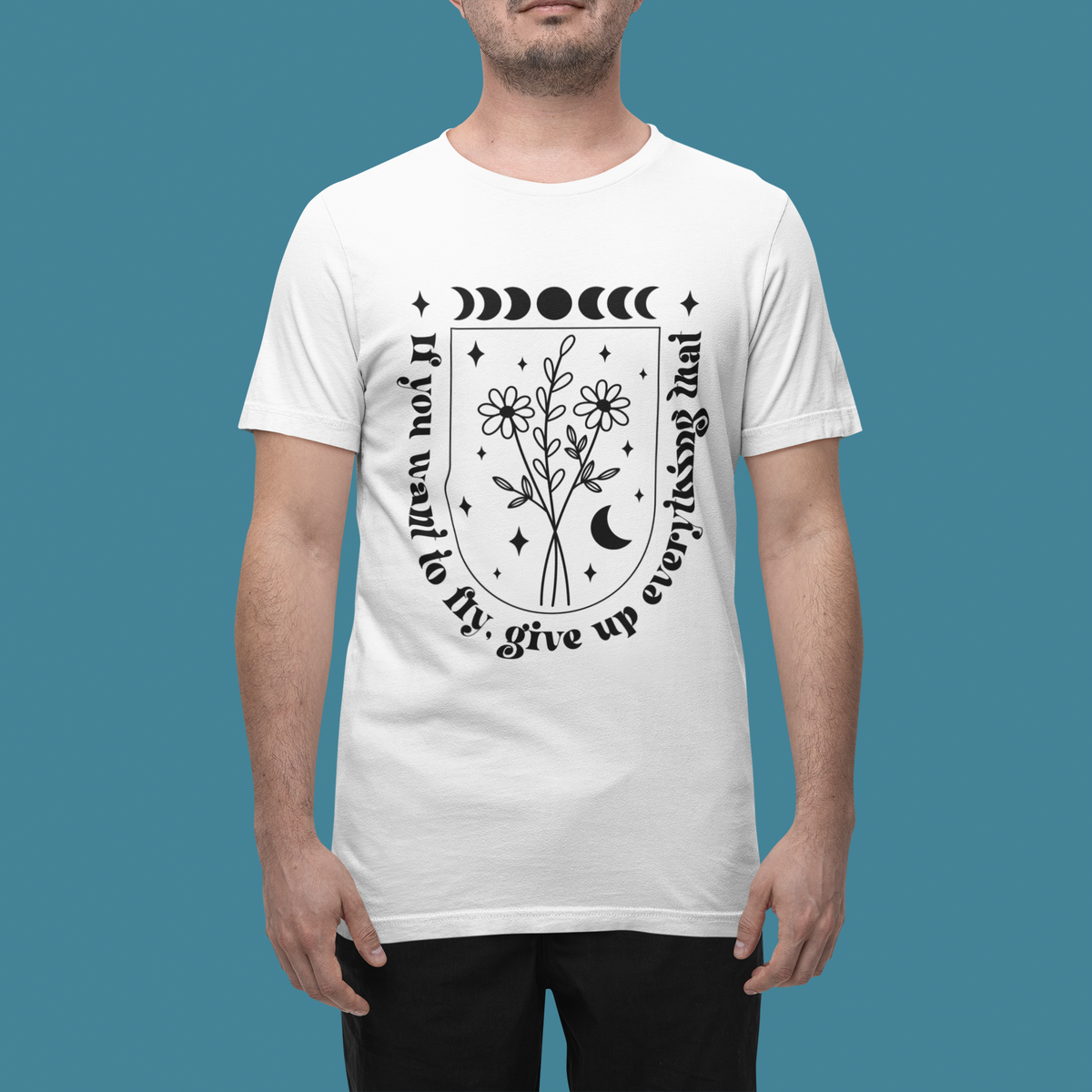 'If You Want To Fly' floral t-shirt in white, man wearing it on teal background