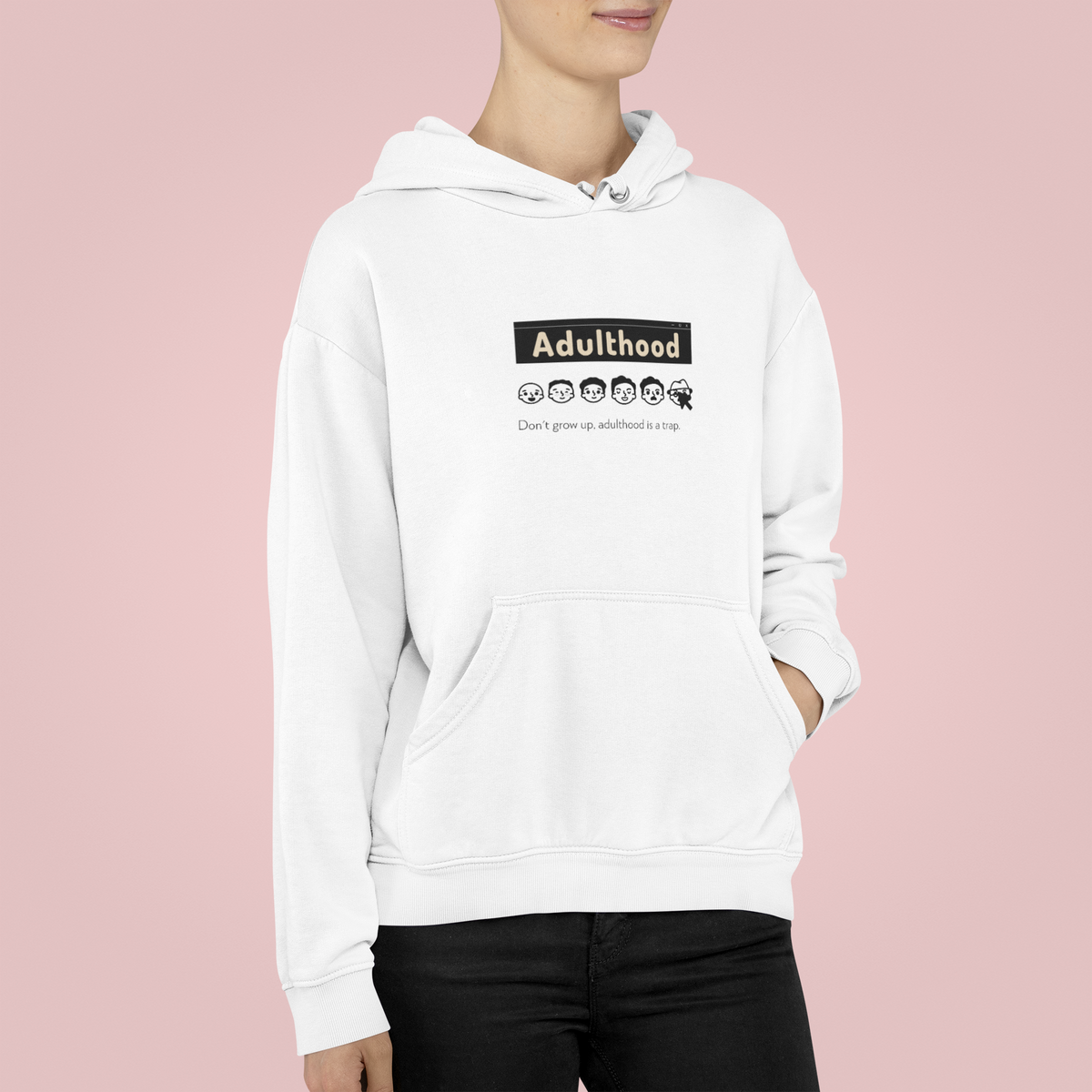 'Adulthood is a Trap' hoodie in white, woman wearing it in studio, funny sarcastic gift idea