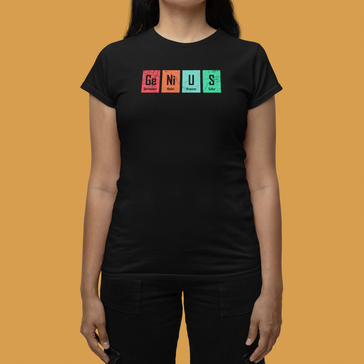 'Genius' periodic table pun women's tee in black, woman on mustard background, funny chemistry tee