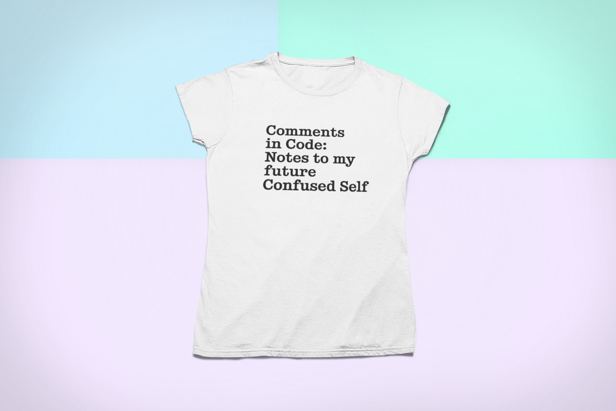 'Comments in Code' t-shirt in white, flat lay on pastel background, funny tech gift