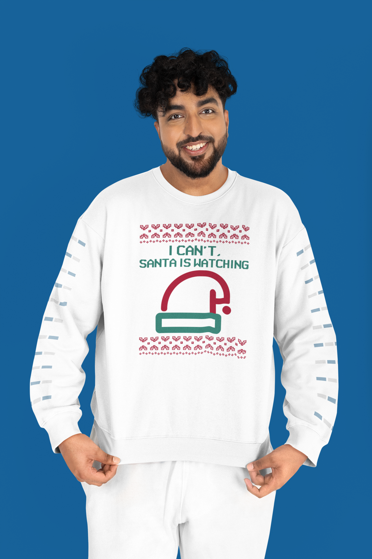 'I Can't Santa Is Watching' camera graphic sweatshirt in white, man wearing it on blue backdrop, funny Christmas gift