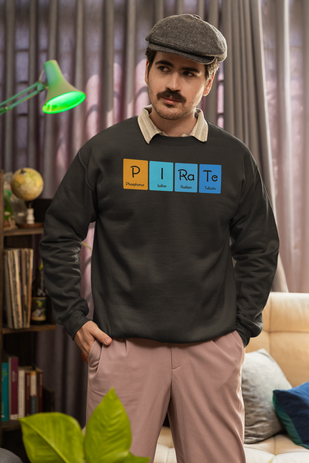 'P-I-Ra-Te' periodic table sweatshirt in olive green, man wearing it indoors, funny chemistry pun gift