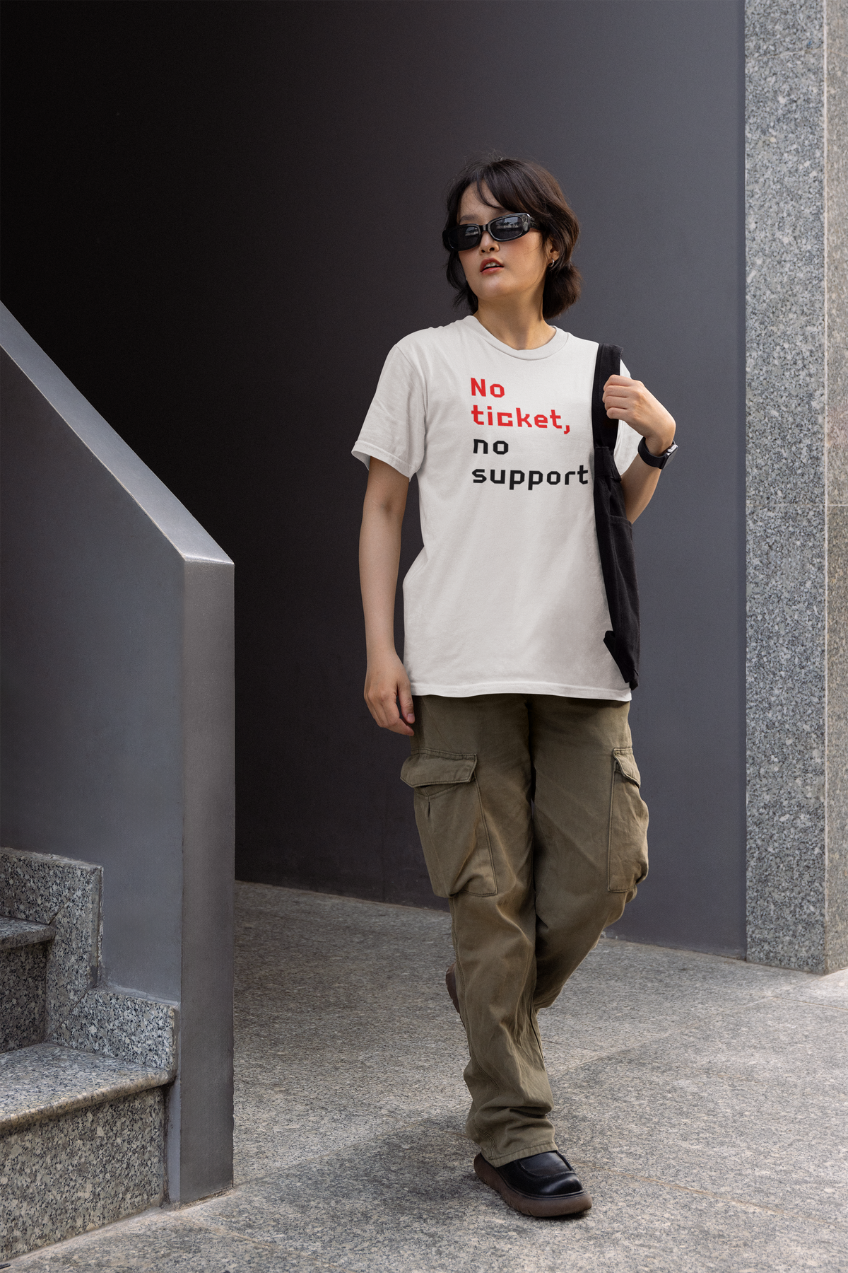 'No Ticket No Support' women's tee in white, woman walking outdoors in the city, funny sysadmin gift