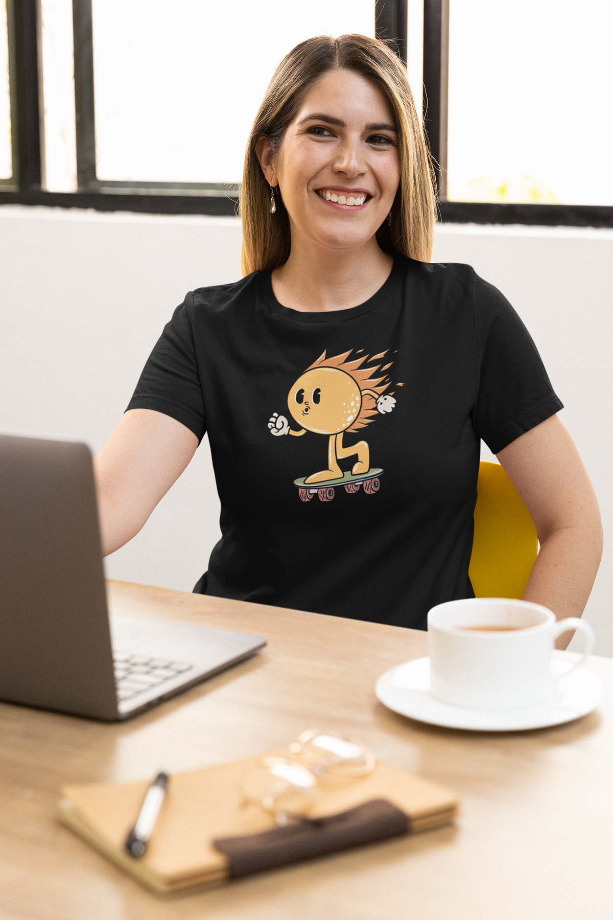'Hot Sun Cartoon' t-shirt in black, woman wearing it at an office desk, T-Shirt mockup, Geekpsters