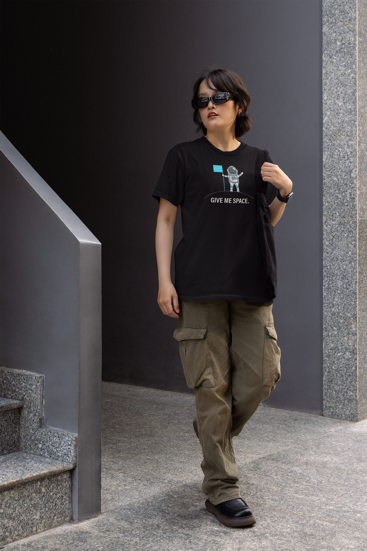 Give Me Space Women's T-Shirt in black, woman walking outdoors wearing it, funny introvert gift