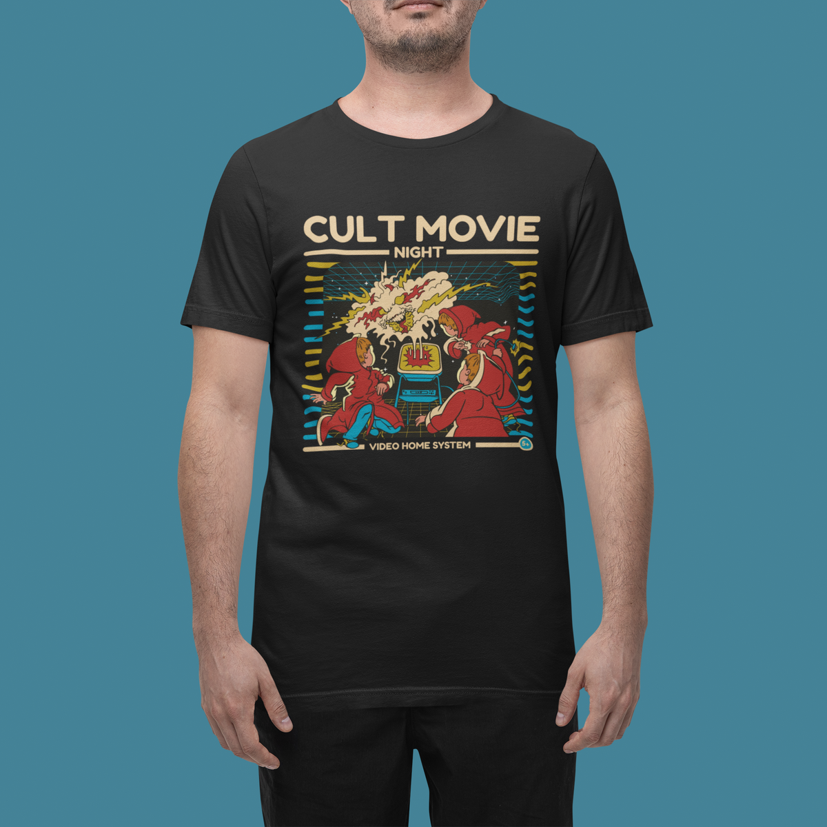 'Cult Movie Night' t-shirt in black, man wearing it on teal background