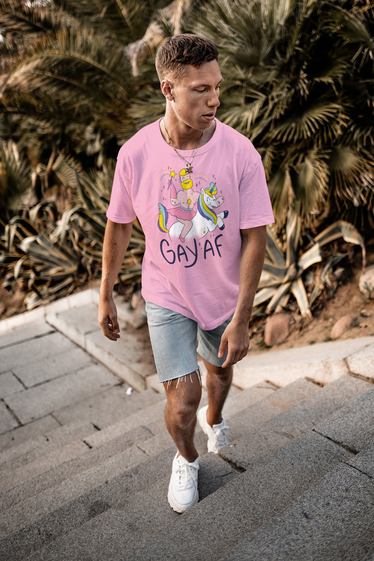 A man walking up stairs in a GAYAF T-Shirt made of 100% cotton.
